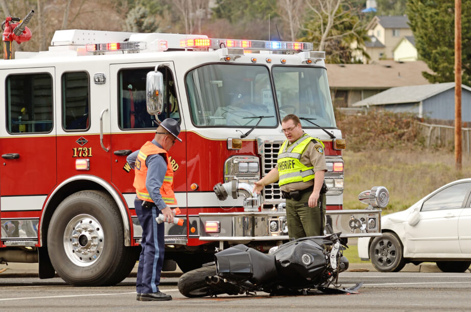 Police examine motorcycle accident scene